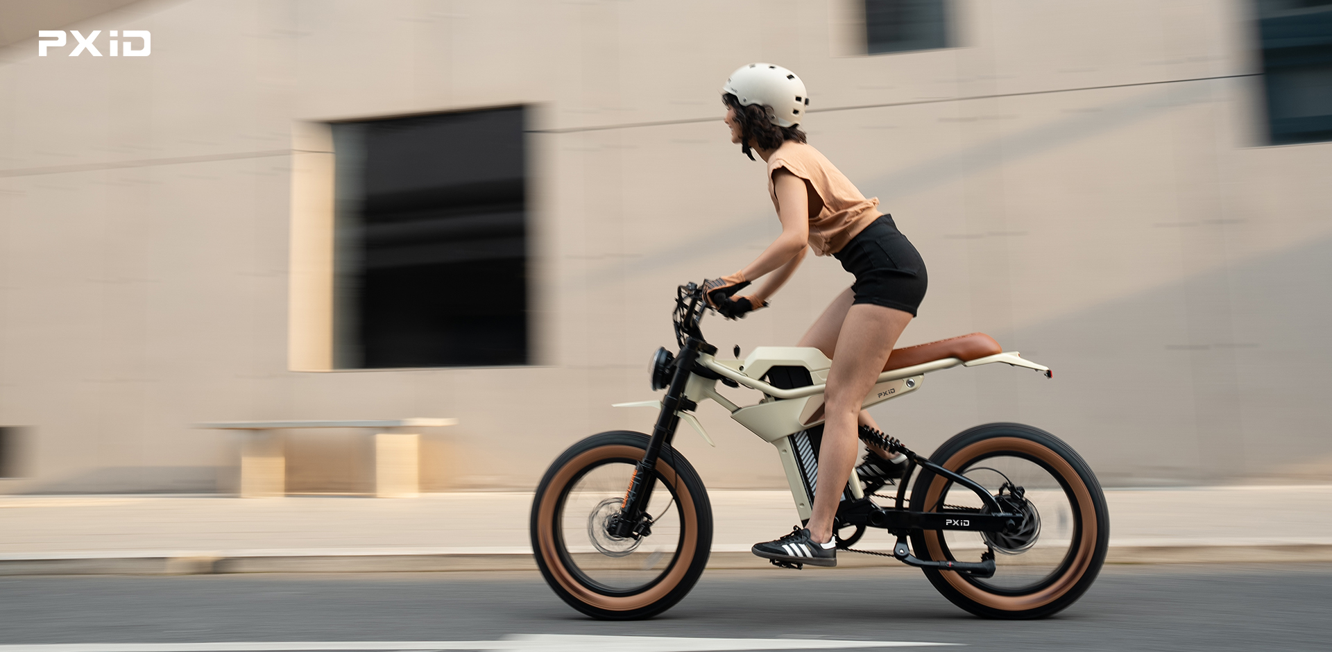 Visitors test electric bicycles and electric scooters in PXID interactive experience zone for urban commuting.