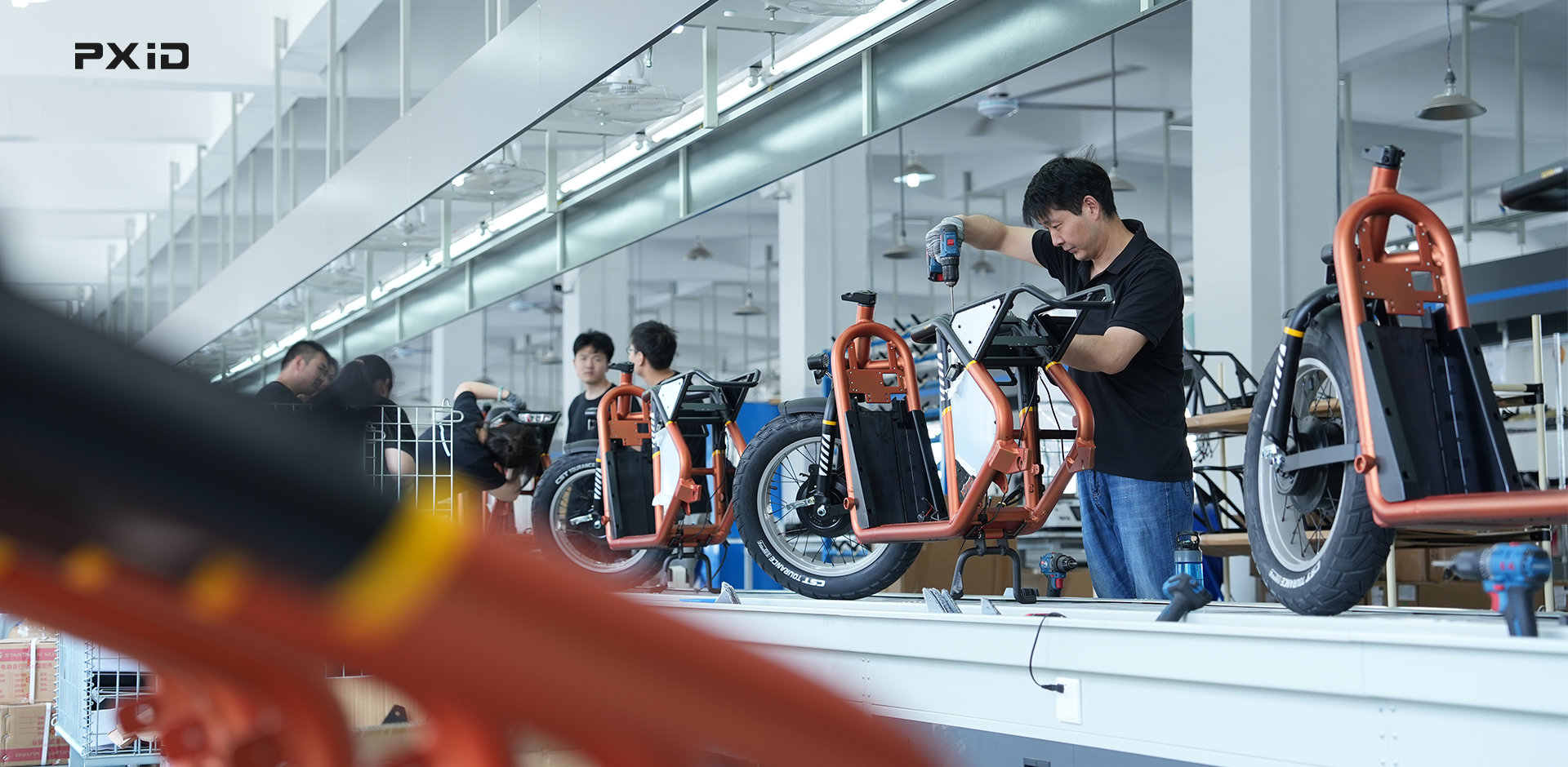Technician assembling electric bicycle components demonstrating manufacturing craftsmanship and precision.