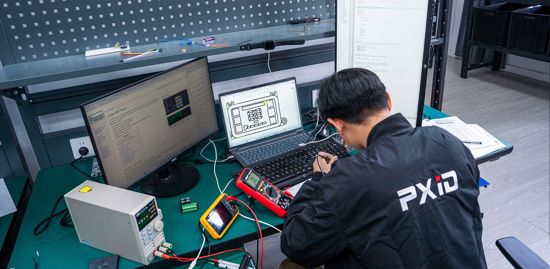 PXID engineers performing integrated software and hardware debugging, ensuring stable operation, precise response, and energy efficiency through precision instruments and road testing.