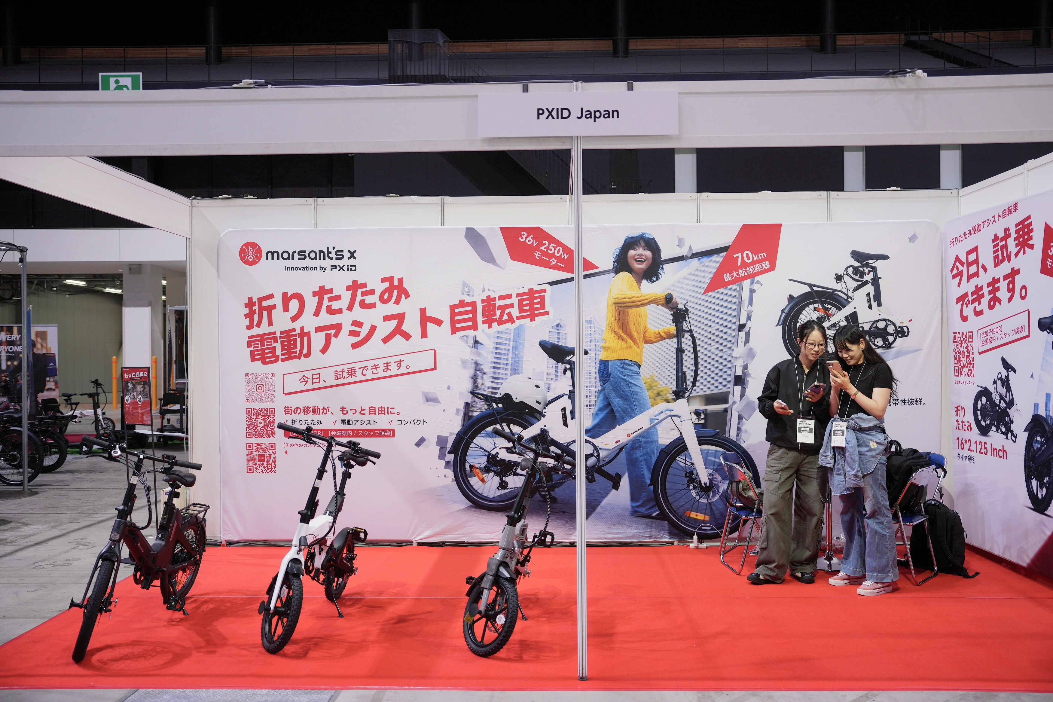 Folding electric assist bicycles at the front of booth E34