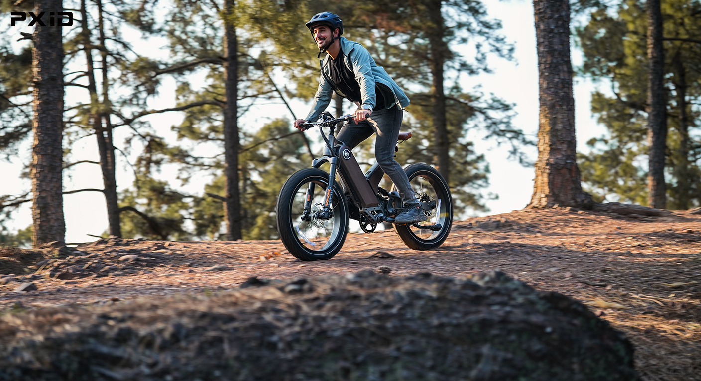 PXID P5 electric bike riding uphill on a mountain trail, showcasing Torque Sensor based pedal assist system for stable and powerful off-road climbing performance in electric mobility applications.